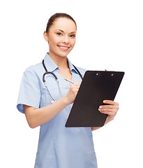 Image showing smiling female doctor or nurse with stethoscope