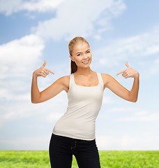 Image showing woman in blank white t-shirt pointing at herself