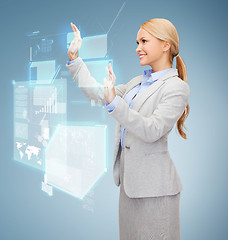 Image showing smiling businesswoman working with virtual screen