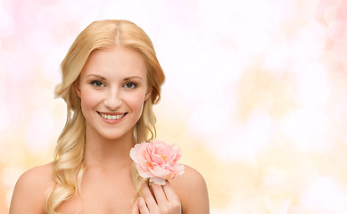 Image showing smiling woman with peony flower