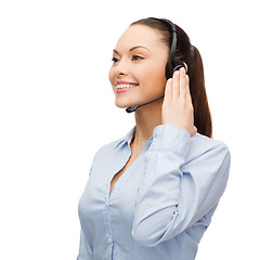 Image showing friendly female helpline operator with headphones