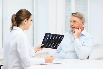 Image showing female doctor with old man looking at x-ray