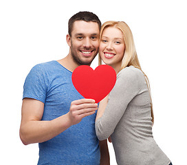 Image showing smiling couple holding big red heart