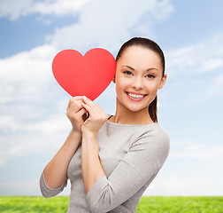 Image showing smiling asian woman with red heart