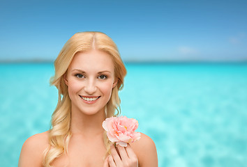 Image showing smiling woman with peony flower