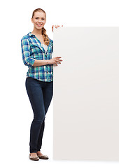 Image showing smiling young woman with white blank board