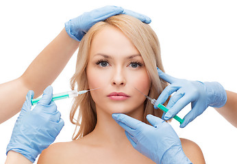 Image showing woman face and beautician hands with syringes