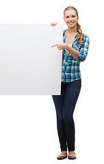 Image showing smiling young woman with white blank board