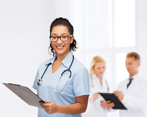 Image showing smiling female african american doctor or nurse