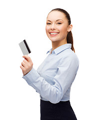 Image showing smiling businesswoman showing credit card