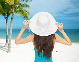 Image showing woman sitting in swimsuit with hat