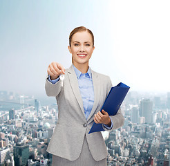 Image showing smiling businesswoman with folder and keys