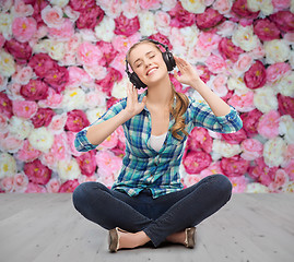 Image showing young woman listeting to music with headphones