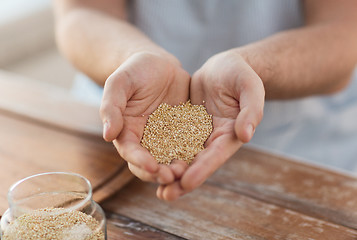 Image showing cloes up of male cupped hands with quinoa
