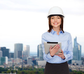 Image showing young smiling businesswoman in white helmet