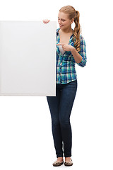 Image showing smiling young woman with white blank board