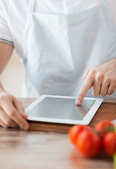 Image showing closeup of man pointing finger to tablet pc