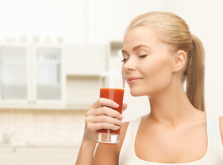 Image showing young woman drinking tomato juice