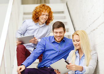 Image showing team with tablet pc computer sitting on staircase