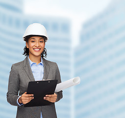 Image showing businesswoman in white helmet with clipboard