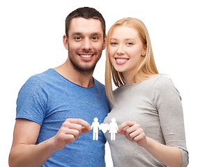 Image showing smiling coule holding paper family with heart