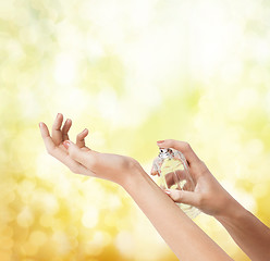 Image showing woman hands spraying perfume