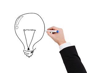 Image showing close up of businessman drawing light bulb