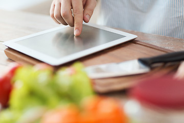 Image showing closeup of man pointing finger to tablet pc