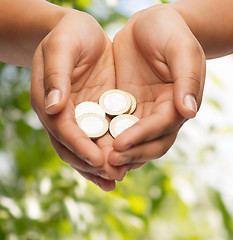 Image showing womans cupped hands showing euro coins