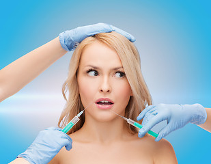 Image showing woman face and beautician hands with syringes