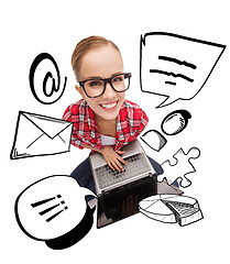 Image showing smiling teenage girl in eyeglasses with laptop