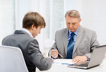 Image showing older man and young man having meeting in office