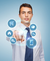 Image showing buisnessman pointing finger to virtual screen