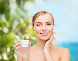 Image showing woman applying cream on her skin