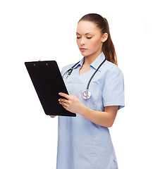 Image showing serious female doctor or nurse with stethoscope