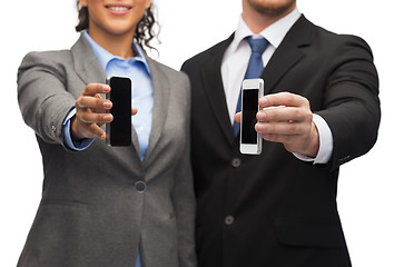 Image showing businessman and businesswoman with smartphones