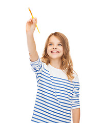 Image showing cute little girl drawing with brush in the air