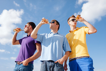 Image showing group of male friends with bottles of beer