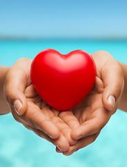 Image showing womans cupped hands showing red heart