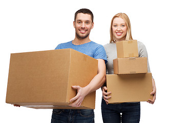 Image showing smiling couple holding cardboard boxes