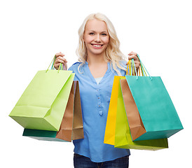 Image showing smiling woman with many shopping bags