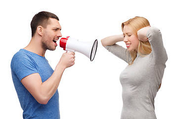 Image showing boyfriend screaming though megaphone at girlfriend