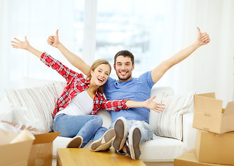 Image showing smiling couple relaxing on sofa in new home