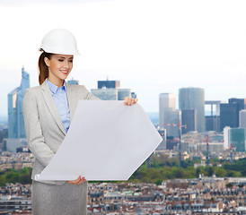 Image showing smiling architect in white helmet with blueprints