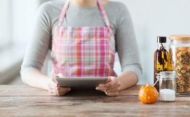 Image showing closeup of woman reading recipe from tablet pc