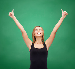 Image showing woman in blank black tank top showing thumbs up