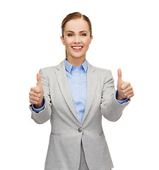 Image showing smiling businesswoman showing thumbs up