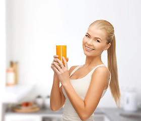 Image showing smiling woman holding glass of orange juice