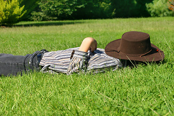 Image showing Child asleep in the grass