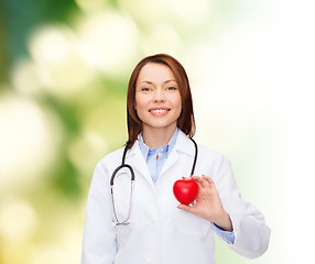 Image showing smiling female doctor with heart and stethoscope